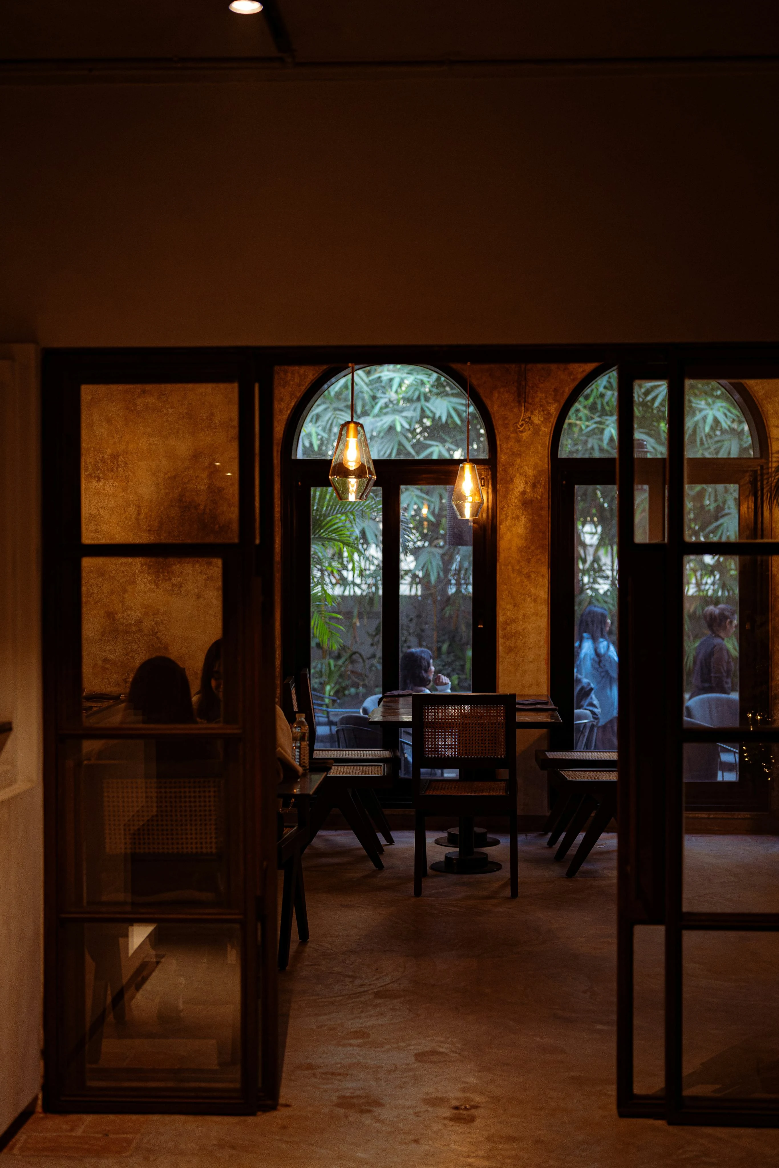 Warm dining room framed by an arched doorway